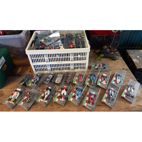 433 - Large collection of small scale Formula 1 cars from the 1950s to the present day, all in Perspex dis... 