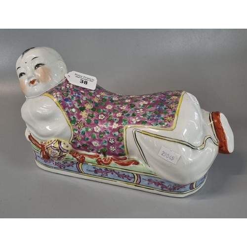 38 - Chinese slip cast porcelain polychrome decorated pillow modelled as a reclining figure of a boy.  Pr... 