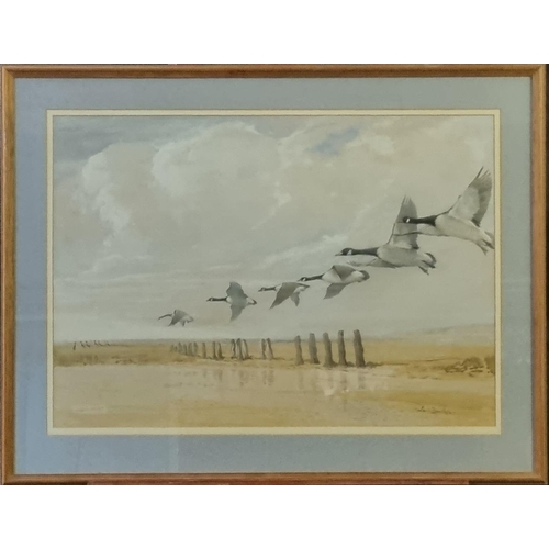 105 - Ruben Ward Binks (British 1880-1950), Canada Geese over sandy beach and groyne, signed.  Watercolour... 