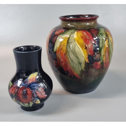 150 - Moorcroft Art Pottery graduated Flambe ground 'Leaf and Berry' design tube lined baluster shaped vas... 