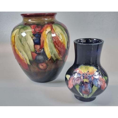 150 - Moorcroft Art Pottery graduated Flambe ground 'Leaf and Berry' design tube lined baluster shaped vas... 