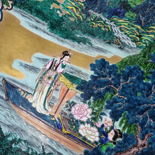 167 - Japanese porcelain Kutani polychrome charger depicting a woman on a boat playing a flute in a landsc... 