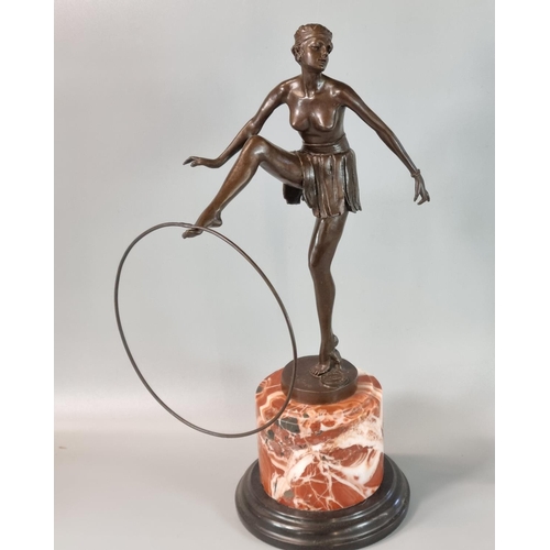 184 - After D Alonzo, an Art Deco style bronze of a semi-nude female dancer with hoop on he outstretched f... 