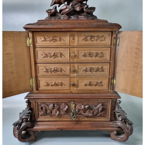 207 - Late 19th century Black Forest walnut Humidor, the top carved with partridge and young above two doo... 