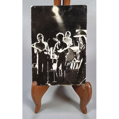 260 - An original 1960s Beatles postcard in black and white featuring the band playing, and with facsimili... 