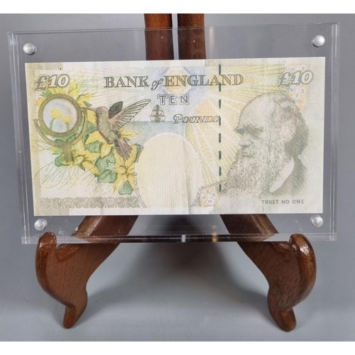 262 - Banksy, a Di'Faced £10 note, an original Bank of England £10 note, the Queen's face substituted with... 