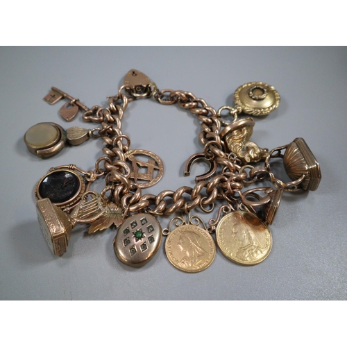 326 - 9ct gold curb link charm bracelet with assorted charms including: Masonic, harp, Intaglio seal fobs ... 