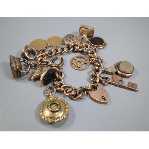 326 - 9ct gold curb link charm bracelet with assorted charms including: Masonic, harp, Intaglio seal fobs ... 