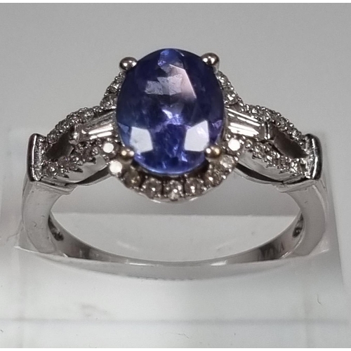 337 - 18ct white gold diamond and Tanzanite ring, of oval form. 5g approx. Size O.  (B.P. 21% + VAT)