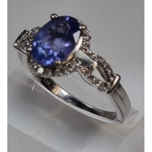 337 - 18ct white gold diamond and Tanzanite ring, of oval form. 5g approx. Size O.  (B.P. 21% + VAT)