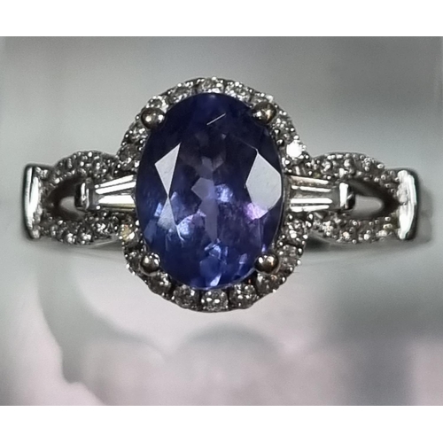 337 - 18ct white gold diamond and Tanzanite ring, of oval form. 5g approx. Size O.  (B.P. 21% + VAT)