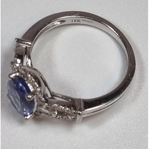 337 - 18ct white gold diamond and Tanzanite ring, of oval form. 5g approx. Size O.  (B.P. 21% + VAT)