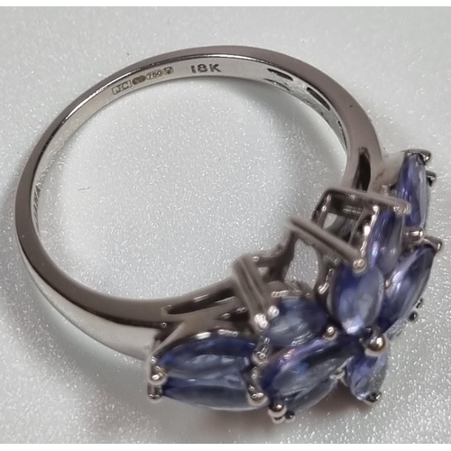 341 - 18ct white gold Iliana blue stone flowerhead design ring. Probably Tanzanite.  4.78g approx.  (B.P. ... 