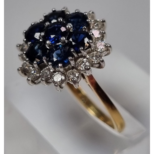 344 - 18ct gold diamond and sapphire ring comprising eighteen diamonds and seven sapphires.  5.2g approx. ... 