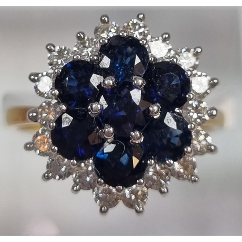 344 - 18ct gold diamond and sapphire ring comprising eighteen diamonds and seven sapphires.  5.2g approx. ... 