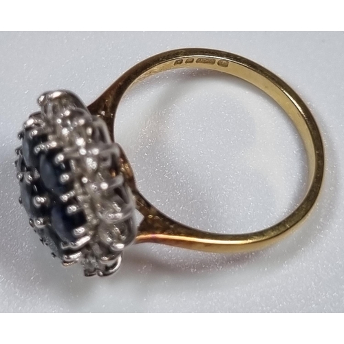 344 - 18ct gold diamond and sapphire ring comprising eighteen diamonds and seven sapphires.  5.2g approx. ... 