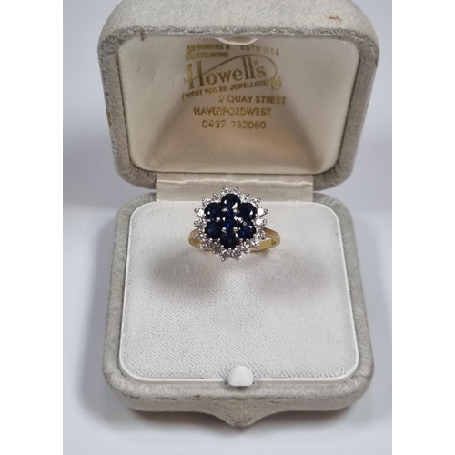 344 - 18ct gold diamond and sapphire ring comprising eighteen diamonds and seven sapphires.  5.2g approx. ... 