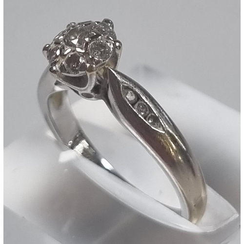 349 - 18ct white gold seven stone diamond ring set with a further three diamond chips to each shoulder, ma... 