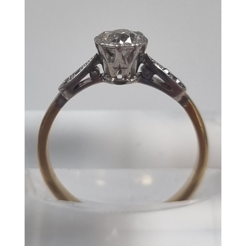 358 - Yellow metal, probably 18ct gold diamond solitaire ring flanked by two further tiny diamonds set to ... 