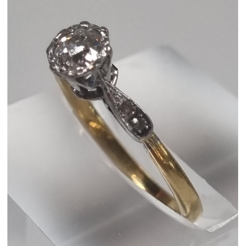 358 - Yellow metal, probably 18ct gold diamond solitaire ring flanked by two further tiny diamonds set to ... 