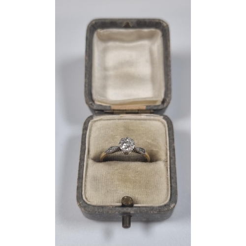 358 - Yellow metal, probably 18ct gold diamond solitaire ring flanked by two further tiny diamonds set to ... 