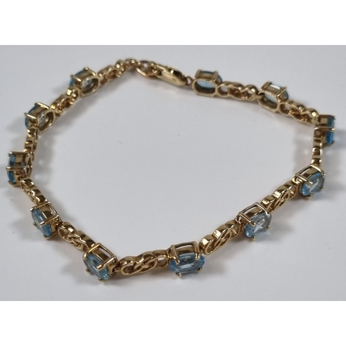 376 - 9ct gold blue topaz multi stone bracelet.  11g approx.  20.5cm long approx.  .  (B.P. 21% + VAT)