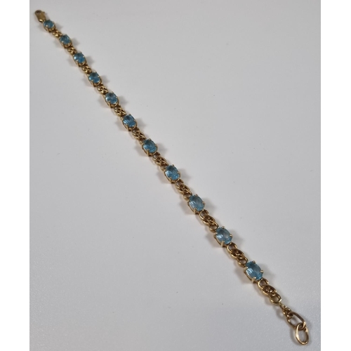 376 - 9ct gold blue topaz multi stone bracelet.  11g approx.  20.5cm long approx.  .  (B.P. 21% + VAT)