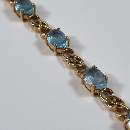 376 - 9ct gold blue topaz multi stone bracelet.  11g approx.  20.5cm long approx.  .  (B.P. 21% + VAT)