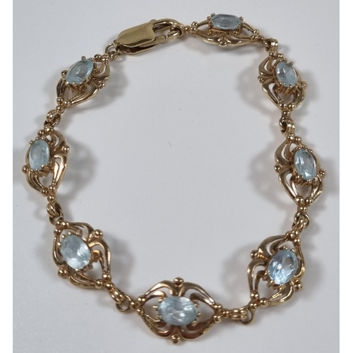 377 - 9ct gold blue eight stone bracelet, probably topaz.  12.2g approx. 19.5cm long approx.  (B.P. 21% + ... 