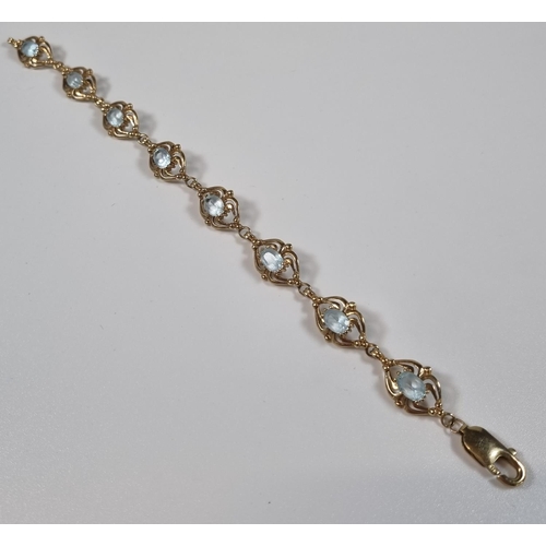 377 - 9ct gold blue eight stone bracelet, probably topaz.  12.2g approx. 19.5cm long approx.  (B.P. 21% + ... 