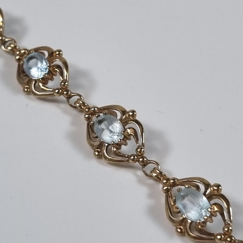 377 - 9ct gold blue eight stone bracelet, probably topaz.  12.2g approx. 19.5cm long approx.  (B.P. 21% + ... 