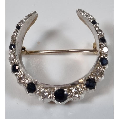 381 - White and yellow metal seventeen stone diamond and sapphire crescent brooch.  6.8g approx.  (B.P. 21... 