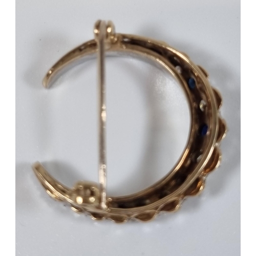 381 - White and yellow metal seventeen stone diamond and sapphire crescent brooch.  6.8g approx.  (B.P. 21... 