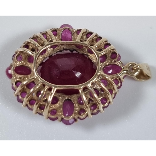 387 - 9ct gold and ruby pendant.  5g approx.  Length 2cm approx.  (B.P. 21% + VAT)