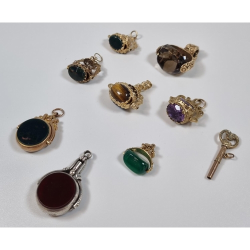 393 - Collection of mainly gold and hardstone swivel pendant fobs including: Tigers eye, Bloodstone, Citri... 