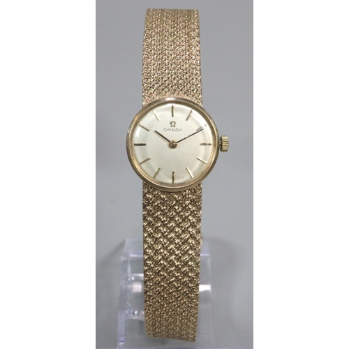 411 - 9ct gold ladies bracelet watch, with satin face having baton numerals ans mesh integral Omega bracel... 