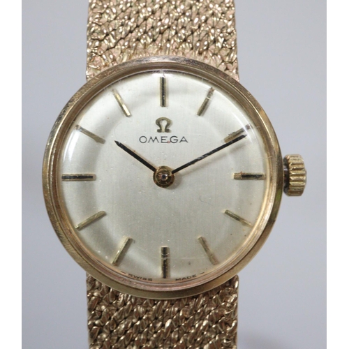 411 - 9ct gold ladies bracelet watch, with satin face having baton numerals ans mesh integral Omega bracel... 