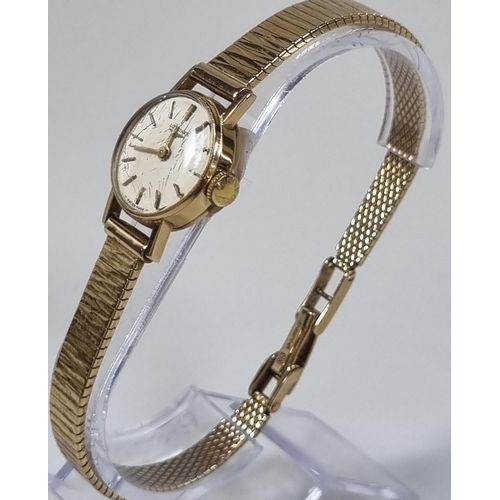 419 - Longines 9ct gold ladies wristwatch with satin face, having baton numerals and 9ct gold bark finish ... 