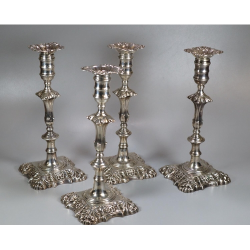 435 - Two similar pairs of18th century Irish silver candlesticks with removeable repoussé sconces above ba...