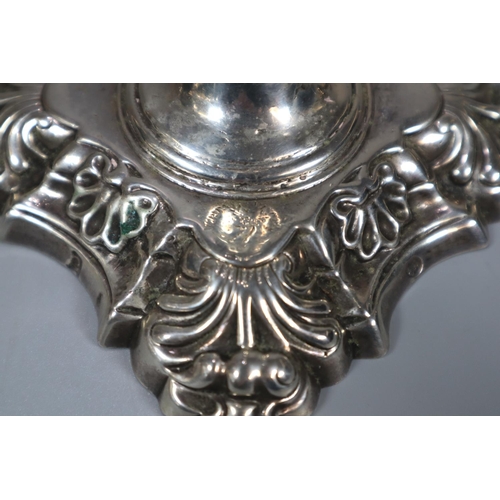 435 - Two similar pairs of18th century Irish silver candlesticks with removeable repoussé sconces above ba... 