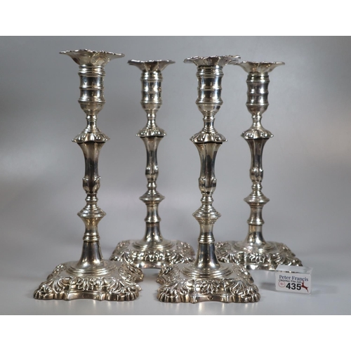 435 - Two similar pairs of18th century Irish silver candlesticks with removeable repoussé sconces above ba... 