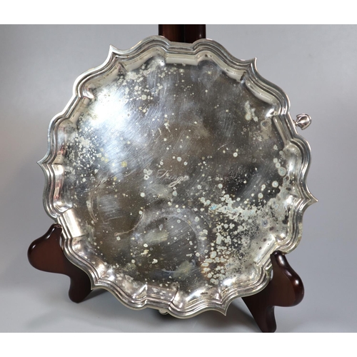 441 - 20th century silver piecrust salver standing on three hoof feet, 21cm diameter approx.  The front ma... 