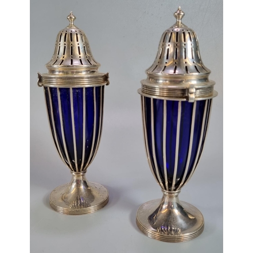 447 - Pair of Edward VII silver sugar casters having Bristol Blue glass liners standing on circular bases,... 