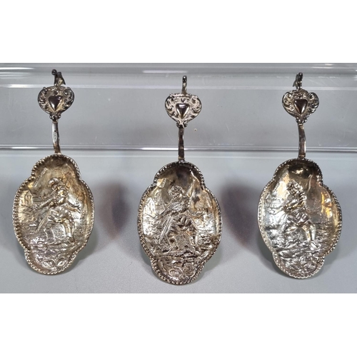 452 - Three Dutch silver spoons with repoussé decoration of a fisherman with his catch and heart shaped te... 