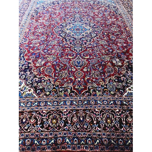 480 - Red and blue ground Persian Kashan carpet with traditional designs, central medallion, flanked by re... 