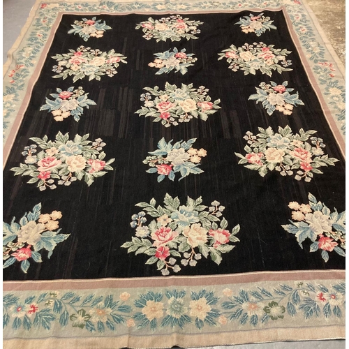 483 - Large Aubusson style floral and foliate black ground needlepoint rug with repeating floral and folia... 