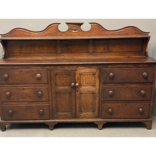 59 - Early 19th century Welsh oak sideboard, the shaped gallery back above a moulded top with an arrangem... 