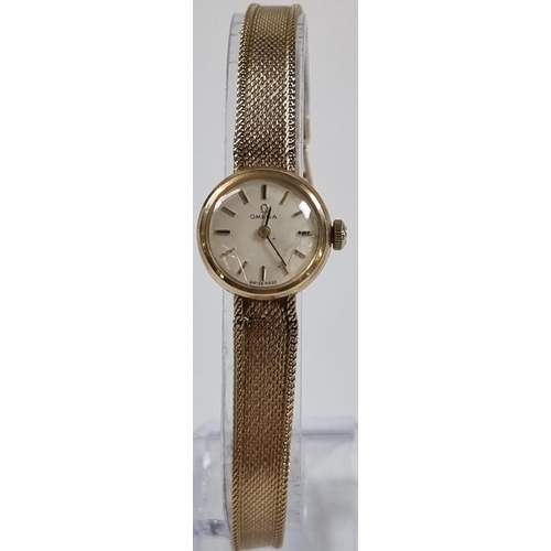 418 - Omega 9ct gold ladies bracelet wristwatch, having satin face with baton numerals and fine mesh brace... 