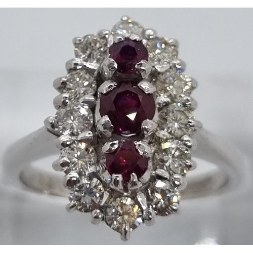 235 - 18ct white gold ring of twelve diamonds and three rubies.  7.4g approx.  Size N1/2.   (B.P. 21% + VA... 