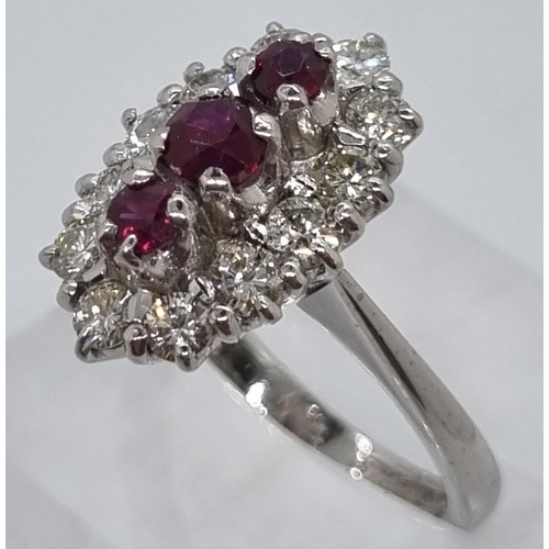 235 - 18ct white gold ring of twelve diamonds and three rubies.  7.4g approx.  Size N1/2.   (B.P. 21% + VA... 